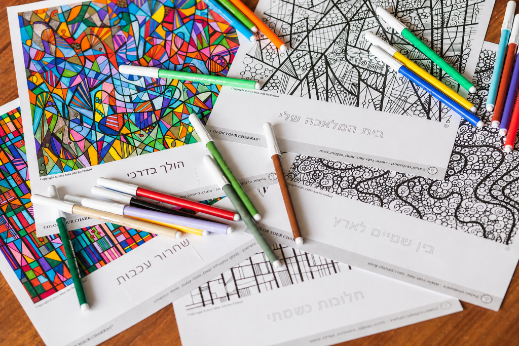 Color Your Chakras patterns with markers on a wooden table